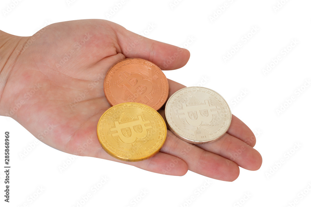 Gold,bronze and silver bitcoins on hand isolate on white background Gold,bronze and silver bitcoins on hand isolate on white background