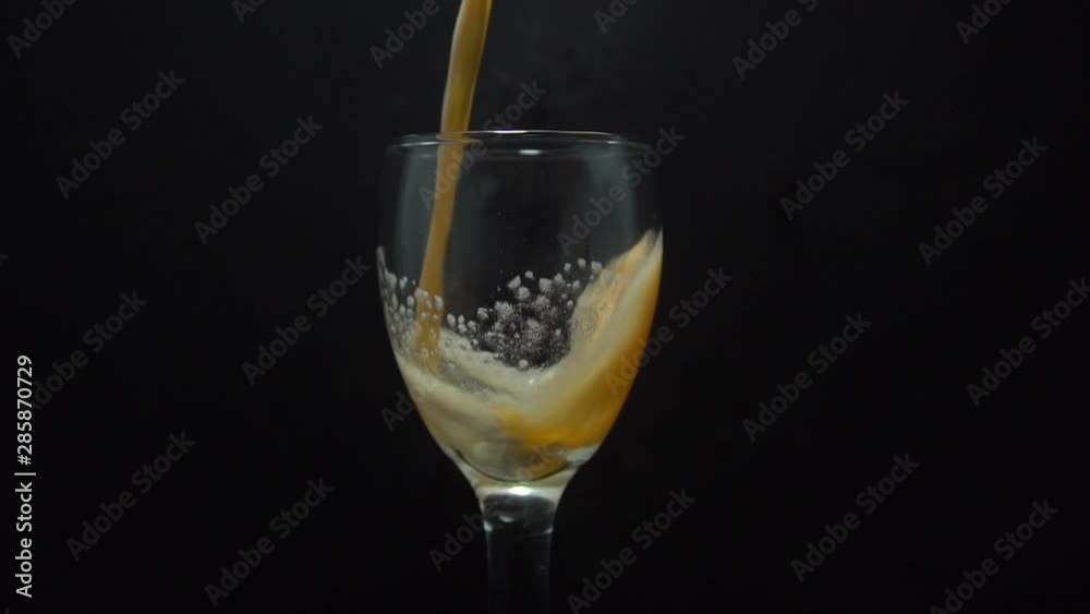 Pouring Milk into empty glass on slow motion footage isolated on black background Pouring Milk into empty glass on slow motion footage isolated on black background