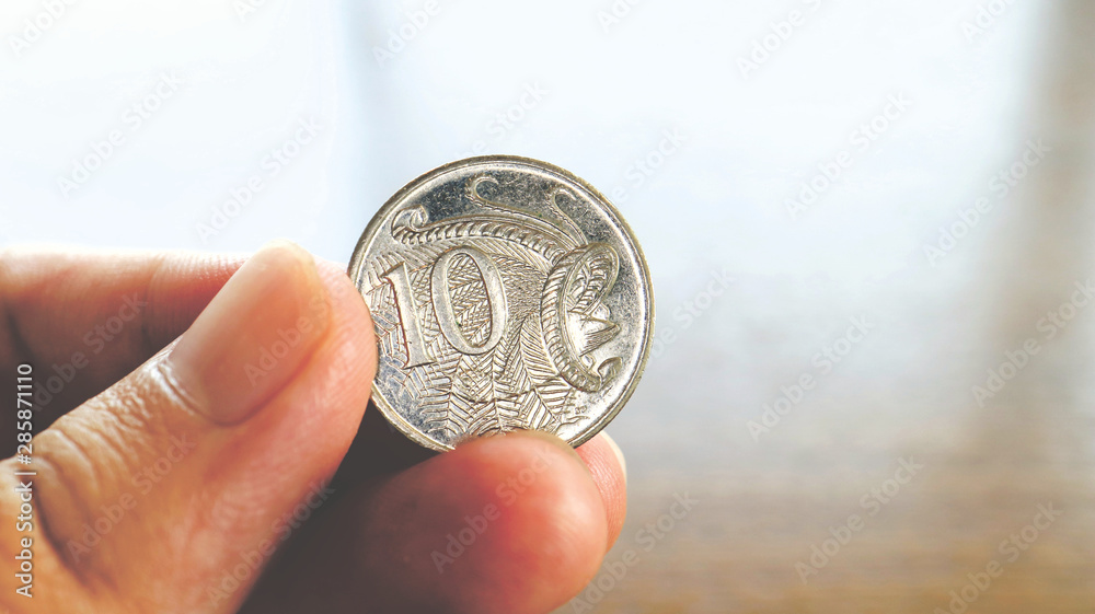 Close the Holding Australian Dollars Coin on Hand and Finger Close the Holding Australian Dollars Coin on Hand and Finger