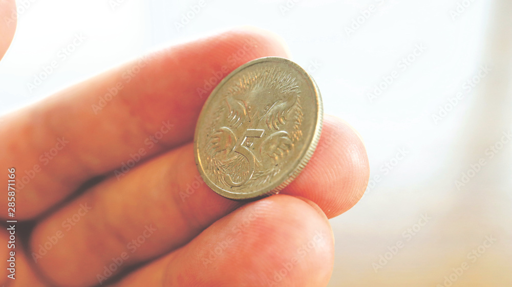 Close the Holding Australian Dollars Coin on Hand and Finger Close the Holding Australian Dollars Coin on Hand and Finger