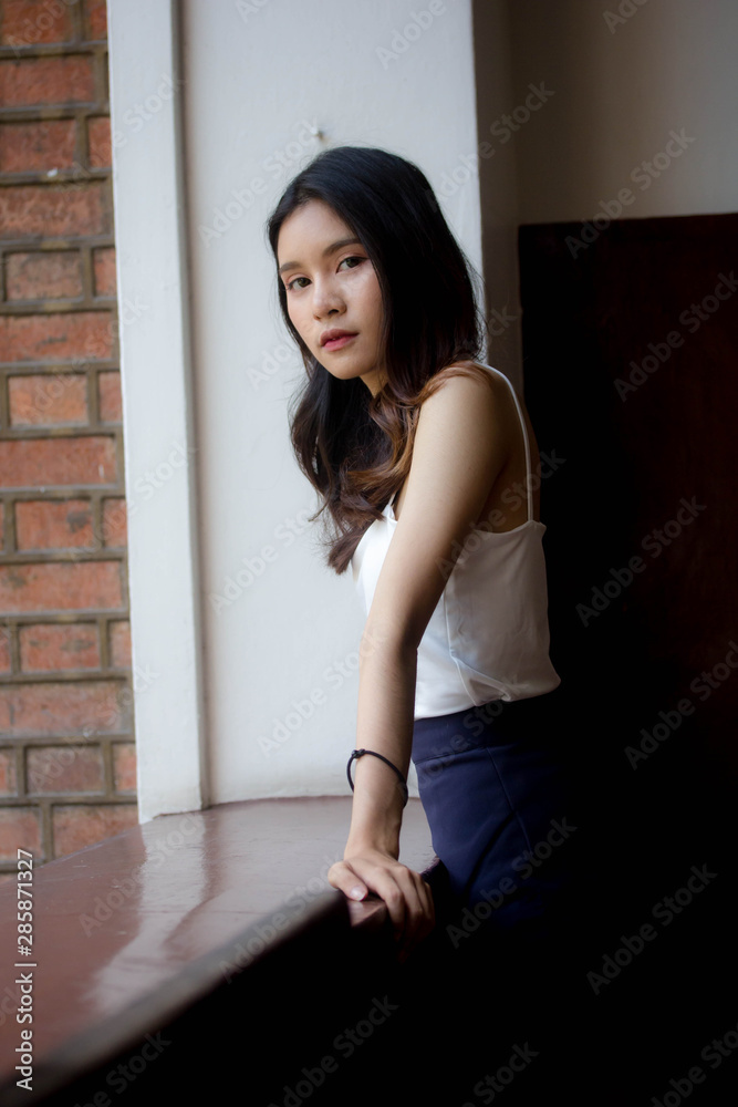 Fototapeta premium Portrait of thai china adult beautiful girl White shirt relax and smile