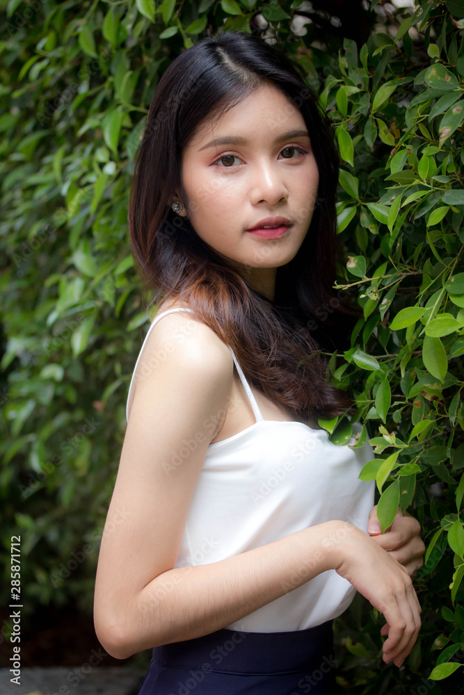 Portrait of thai china adult beautiful girl White shirt relax and smile Portrait of thai china adult beautiful girl White shirt relax and smile