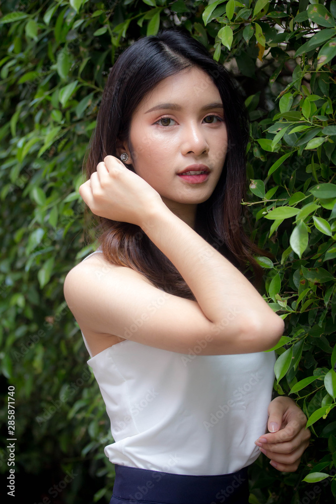 Portrait of thai china adult beautiful girl White shirt relax and smile Portrait of thai china adult beautiful girl White shirt relax and smile
