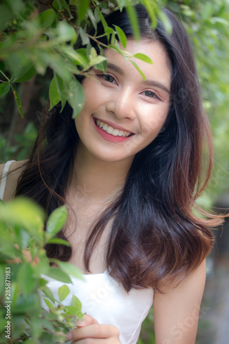Portrait of thai china adult beautiful girl White shirt relax and smile