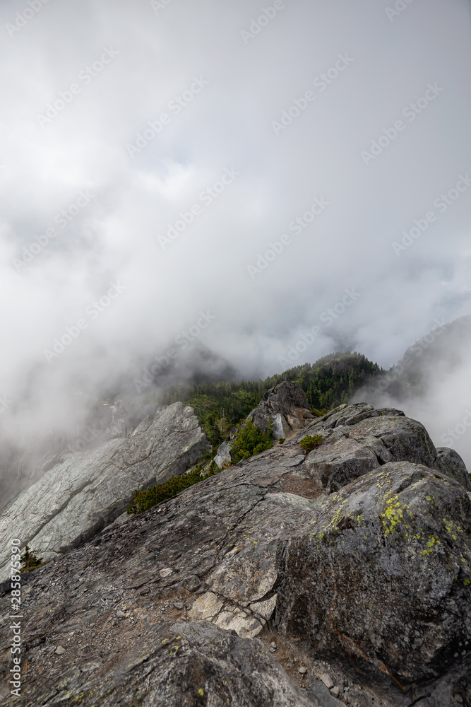 Beautiful View of Canadian Mountain Landscape during a cloudy summer morning. Taken on Crown Mountain, North Vancouver, British Columbia, Canada.