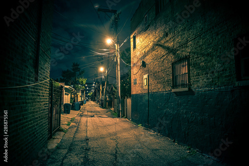 Dark and eerie urban city alley at night © Bruno Passigatti
