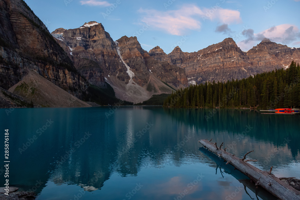 Beautiful view of an Iconic Famous Place, Moraine Lake, during a vibrant summer sunrise. Located in Banff National Park, Alberta, Canada.