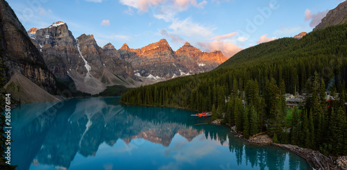 Beautiful Panoramic view of an Iconic Famous Place, Moraine Lake, during a vibrant summer sunrise. Located in Banff National Park, Alberta, Canada.