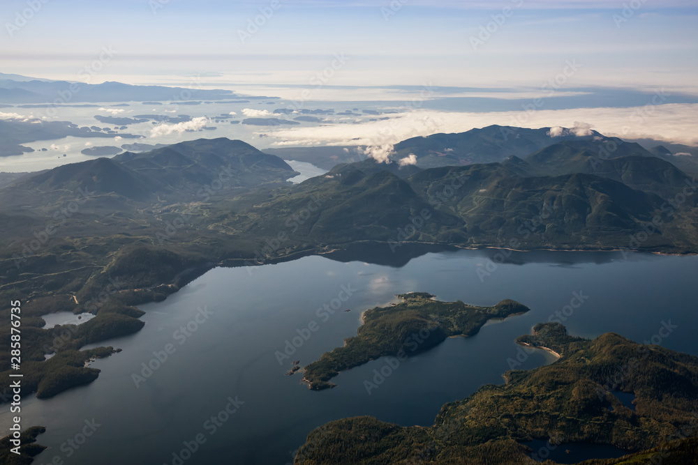 Aerial Landscape View of Kennedy Lake and Pacific Ocean Coast during a sunny summer morning. Taken near Tofino and Ucluelet, Vancouver Island, British Columbia, Canada.