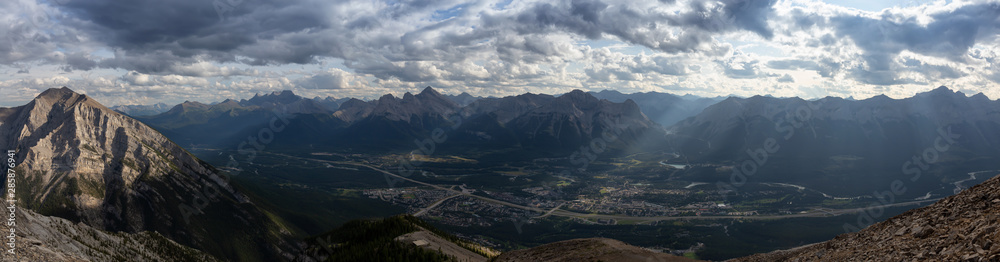 Beautiful Panoramic View of Canadian Rocky Mountain Landscape during a cloudy and rainy day. Taken from Mt Lady MacDonald, Canmore, Alberta, Canada.