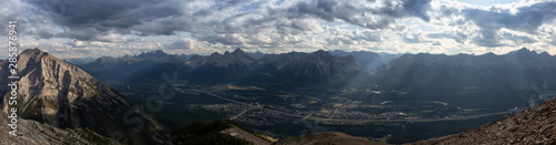 Beautiful Panoramic View of Canadian Rocky Mountain Landscape during a cloudy and rainy day. Taken from Mt Lady MacDonald, Canmore, Alberta, Canada.