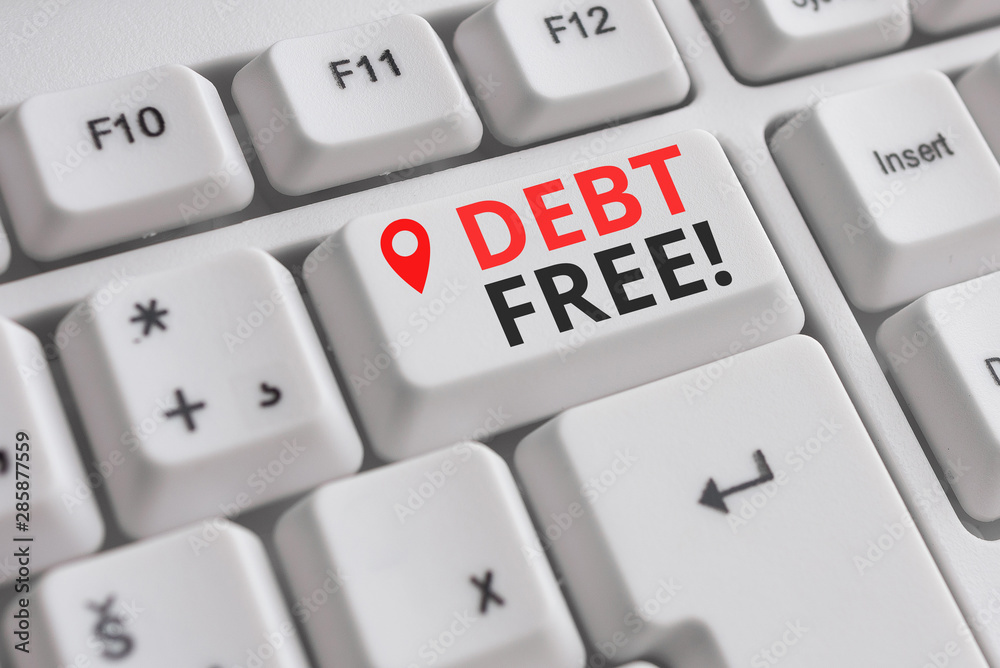 Handwriting text Debt Free. Conceptual photo does not owning any money or things to any individual or companies White pc keyboard with empty note paper above white background key copy space Handwriting text Debt Free. Conceptual photo does not owning any money or things to any individual or companies White pc keyboard with empty note paper above white background key copy space