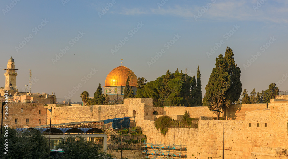 Sunset over the Temple mount with Wailing Wall, mosque Al-aqsa (Dome of the Rock) and minaret in Jerusalem