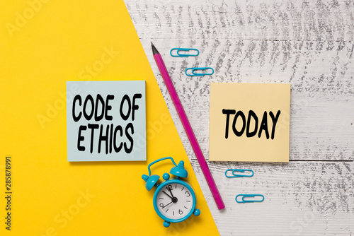 Word writing text Code Of Ethics. Business photo showcasing basic guide for professional conduct and imposes duties Notepads marker pen colored paper sheet alarm clock wooden background