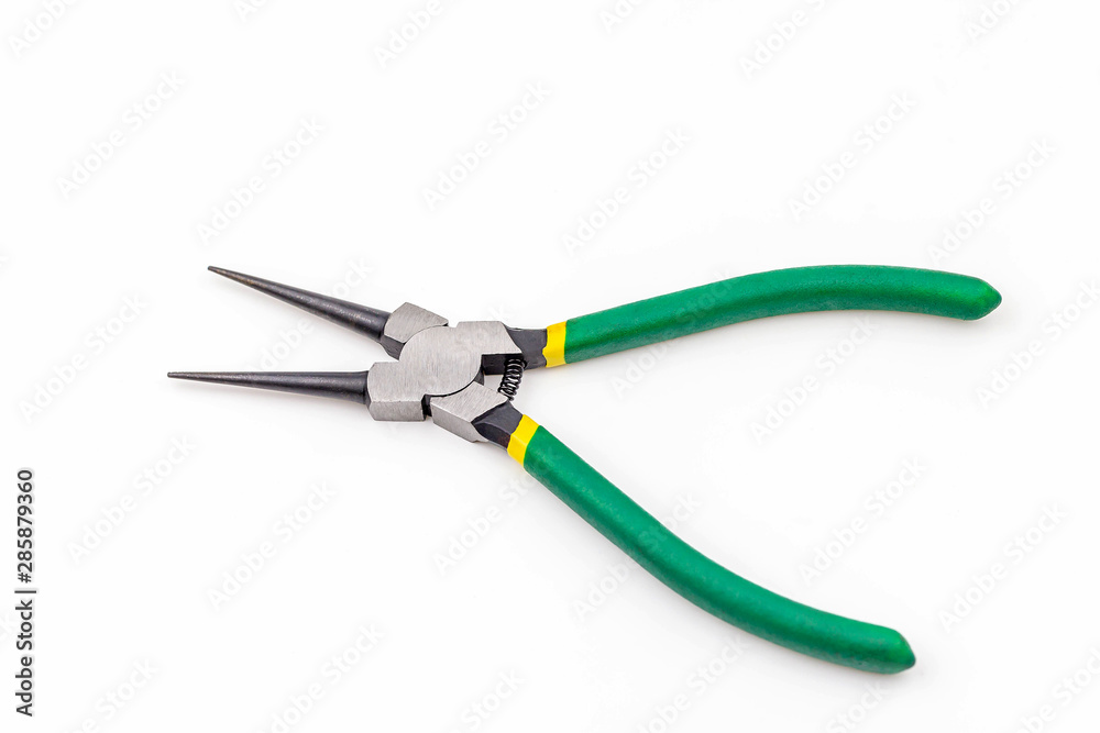 Opened combination pliers with green grasp on white background Opened combination pliers with green grasp on white background