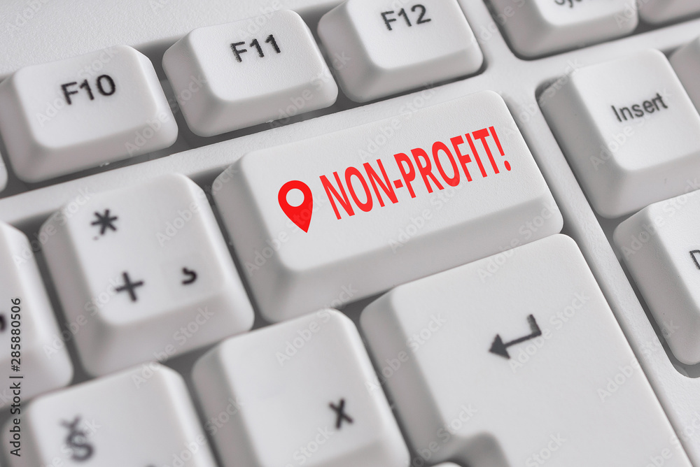 Handwriting text NonProfit. Conceptual photo not making or conducted primarily to make profit organization White pc keyboard with empty note paper above white background key copy space