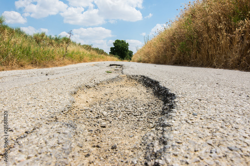 Big pothole on a national road in Sicily caused by landslide  carelessness and abandonment of road maintenance