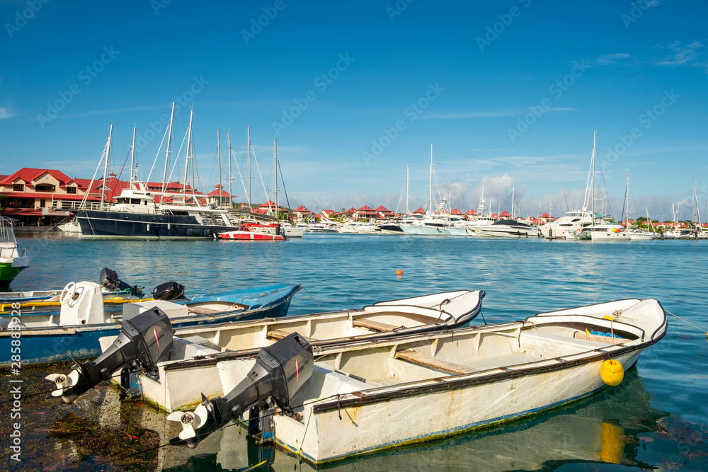 Old vintage fishing boats in sunny summer day at marina of Eden Island, Mahe, Seychelles