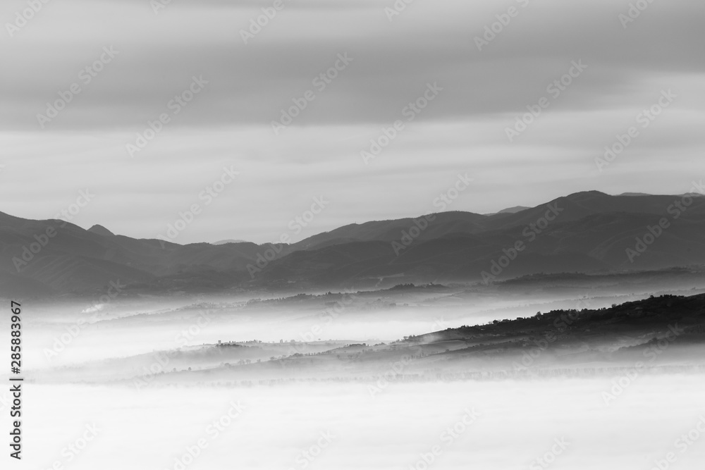 Fototapeta premium A view of Umbria valley with hills and mist