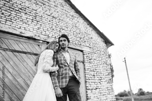 A young couple of brides have a fun and walking in the field outdoor