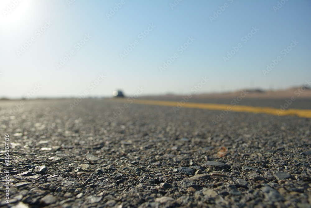 close up of asphalt road in desert close up of asphalt road in desert
