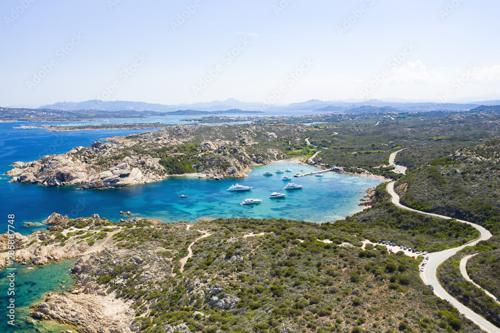 View from above, stunning aerial view of the Maddalena Archipelago National Park with some islands surrounded by a beautiful turquoise clear sea, Caprera island in the distance. Sardinia, Italy.