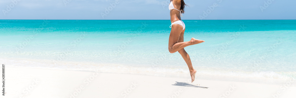 Sexy bikini body perfect slim legs for summer beach holidays panoramic banner. Woman jumping of happiness for weight loss, laser treatment for cellulite, hair removal, concept. Copy space on ocean. Sexy bikini body perfect slim legs for summer beach holidays panoramic banner. Woman jumping of happiness for weight loss, laser treatment for cellulite, hair removal, concept. Copy space on ocean.