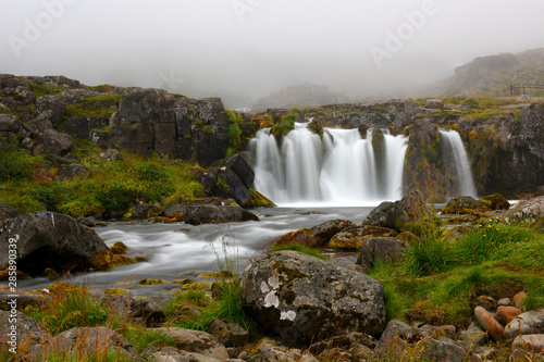 Long exposure photo of waterfall  view of the small waterfall in Westfjords of Iceland  Europe.