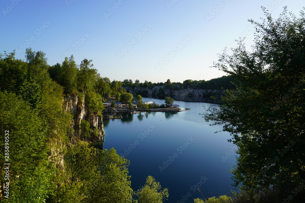 lake among the rocky mountains, turquoise clear water, wild nature, the sun's reflection in water, reflection of mountains in the clear water