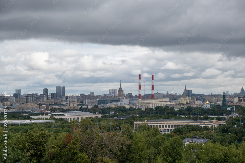 view from Sparrow hills to the Ostankino TV tower, Russian government building, two soviet skyscrapers and power station with smoking pipes
