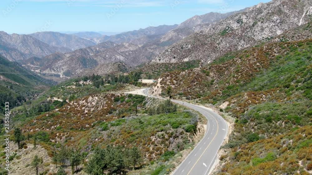 Asphalt road bends through Angeles National forests mountain, California, USA. Thin road winds between a ridge of hills and mountains at high altitude Asphalt road bends through Angeles National forests mountain, California, USA. Thin road winds between a ridge of hills and mountains at high altitude