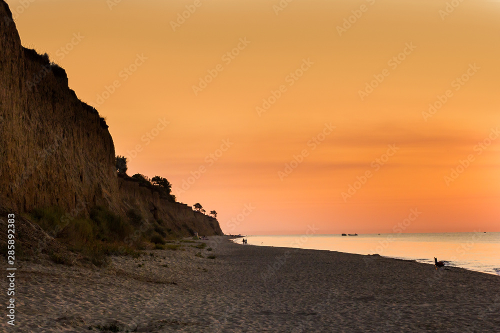 dawn on the beach of the Black Sea in orange tones