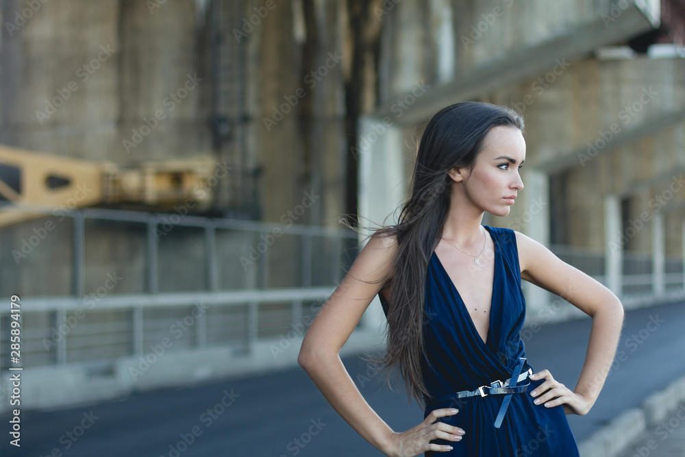 Sexy young beauty woman posing over hydroelectric power station background