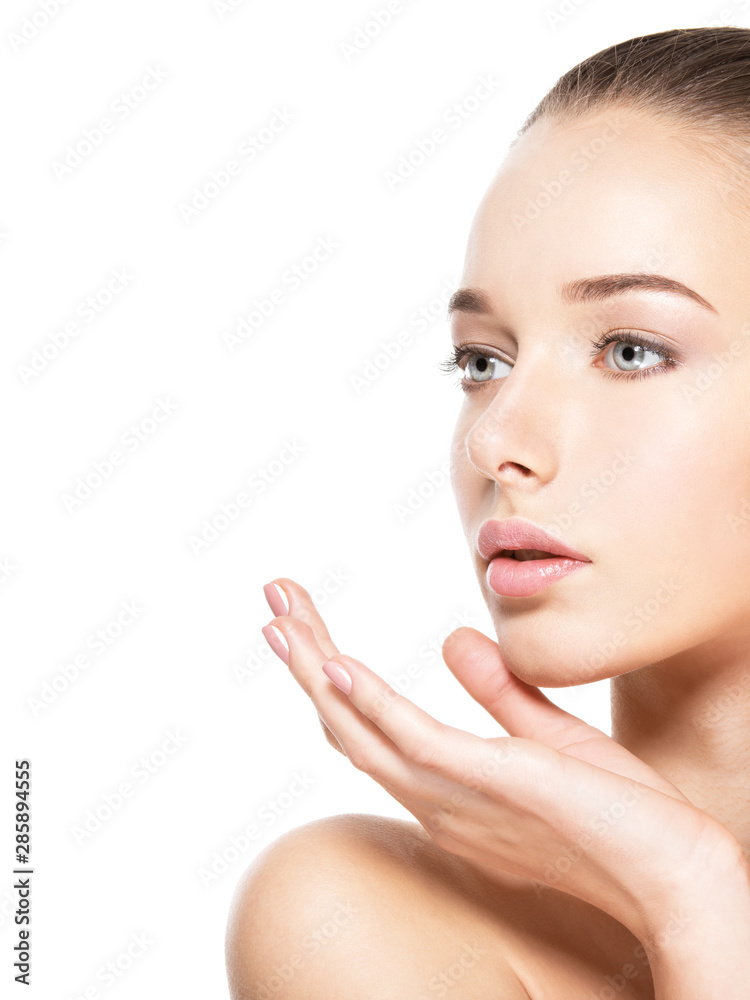 Young woman with healthy clean skin touches the face. Skin care concept. Young woman with healthy clean skin touches the face. Skin care concept.