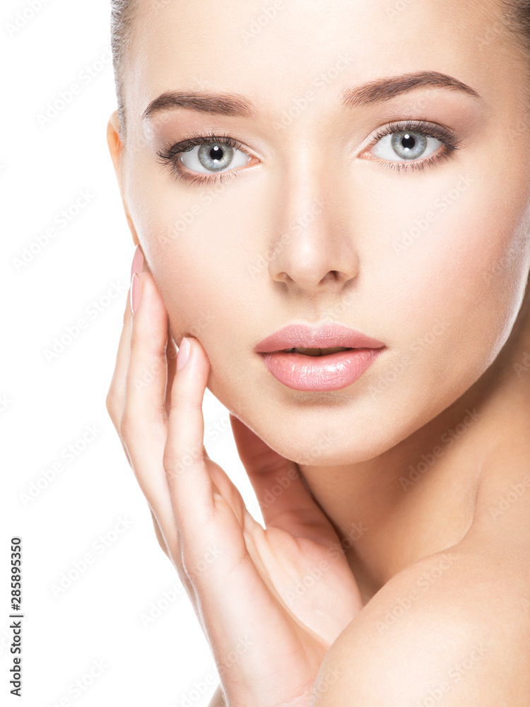 Young woman with healthy clean skin touches the face. Skin care concept. Young woman with healthy clean skin touches the face. Skin care concept.