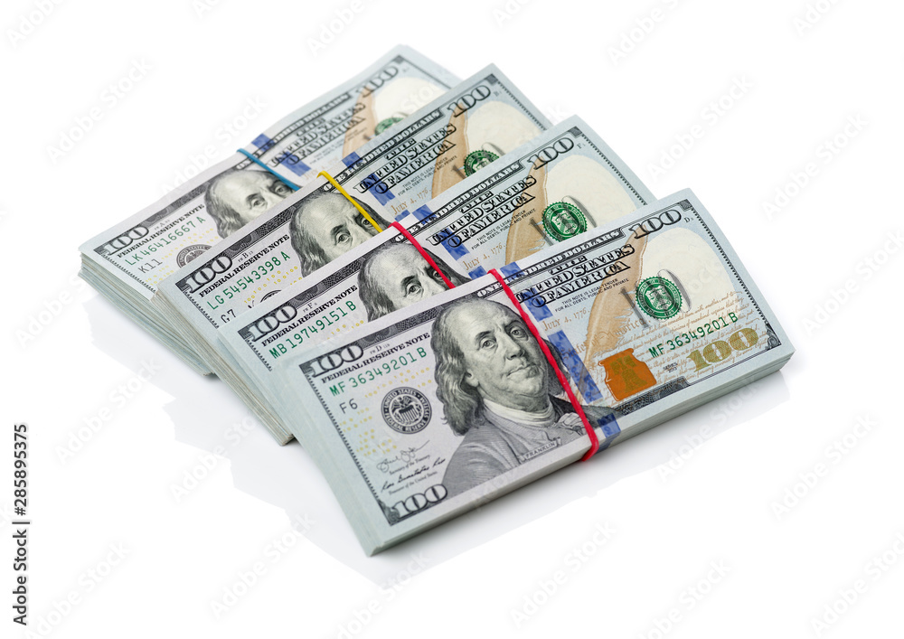 Many bundle of US 100 dollars bank notes isolated on white background Many bundle of US 100 dollars bank notes isolated on white background