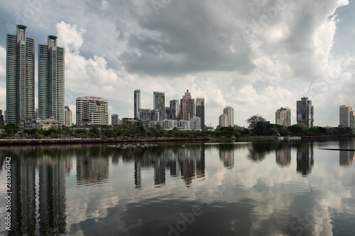 Skyline of Bangkok with Water or Lake in the foreground and big Clouds in the Sky © Simon