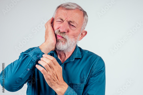 Принти на полотні unhappy senior man with closed eyes holding cheek isolated white background, str