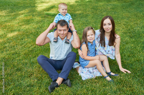 family mom, father, son and daughter in the park