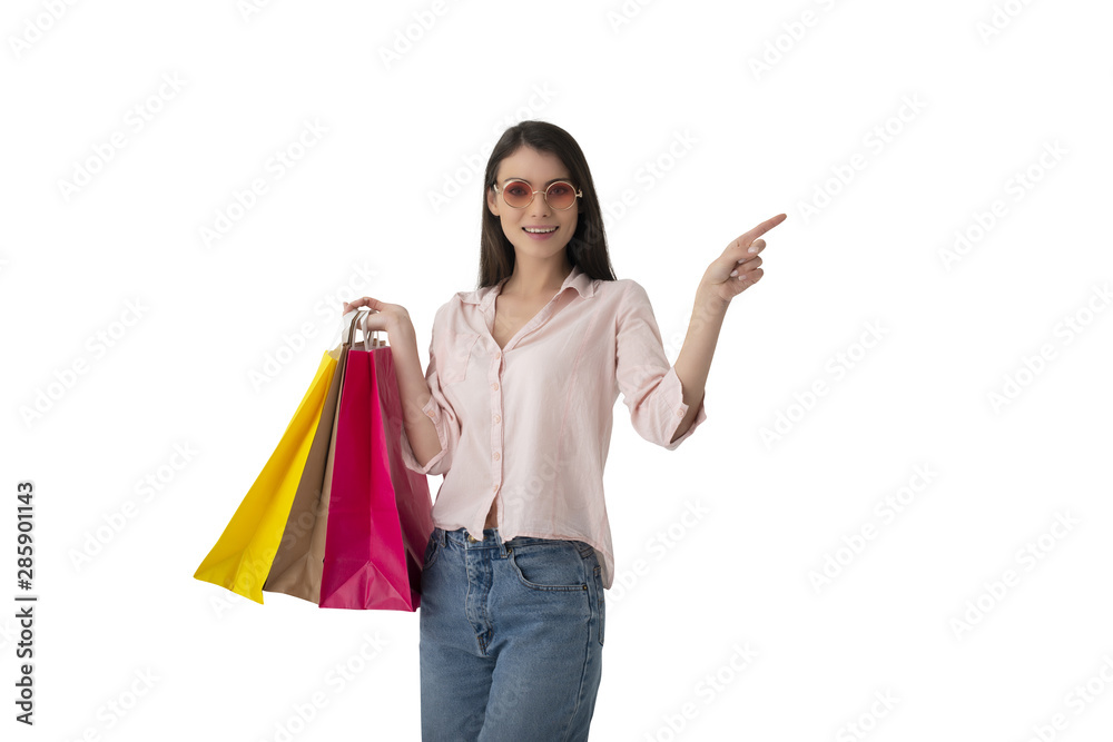 Happy woman with shopping bags in hand indicates something Happy woman with shopping bags in hand indicates something