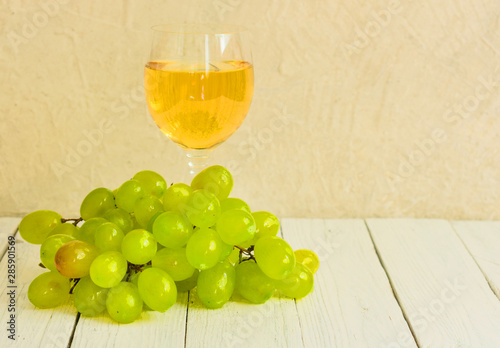 Wallpaper Mural Glass of white wine and grapes on a white wooden background. Copy space. Torontodigital.ca