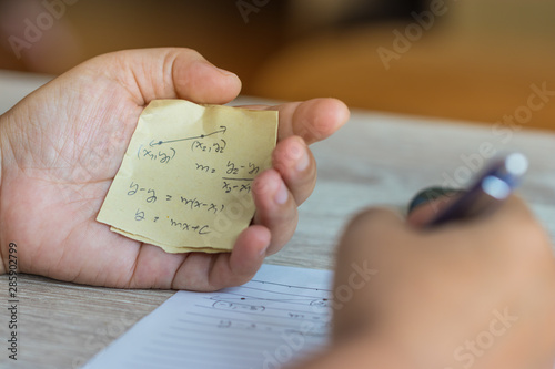 Quadro em tela Student using formula math sheet to cheat on test