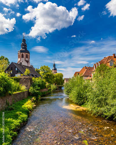 Old city of Ettlingen in Germany with a river and a church. View of a central district of Ettlingen, Germany, with a river and a bell tower of a church. Ettlingen, Baden Wurttemberg, Germany.