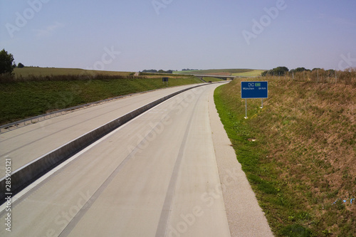 Autobahn A94 at Heldenstein with street sign distance to Munich 64 Km open up new highway photo