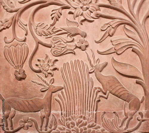 Ancient bas-relief with flowers and hunting animals in Junagarh fort in Bikaner, Rajasthan, India