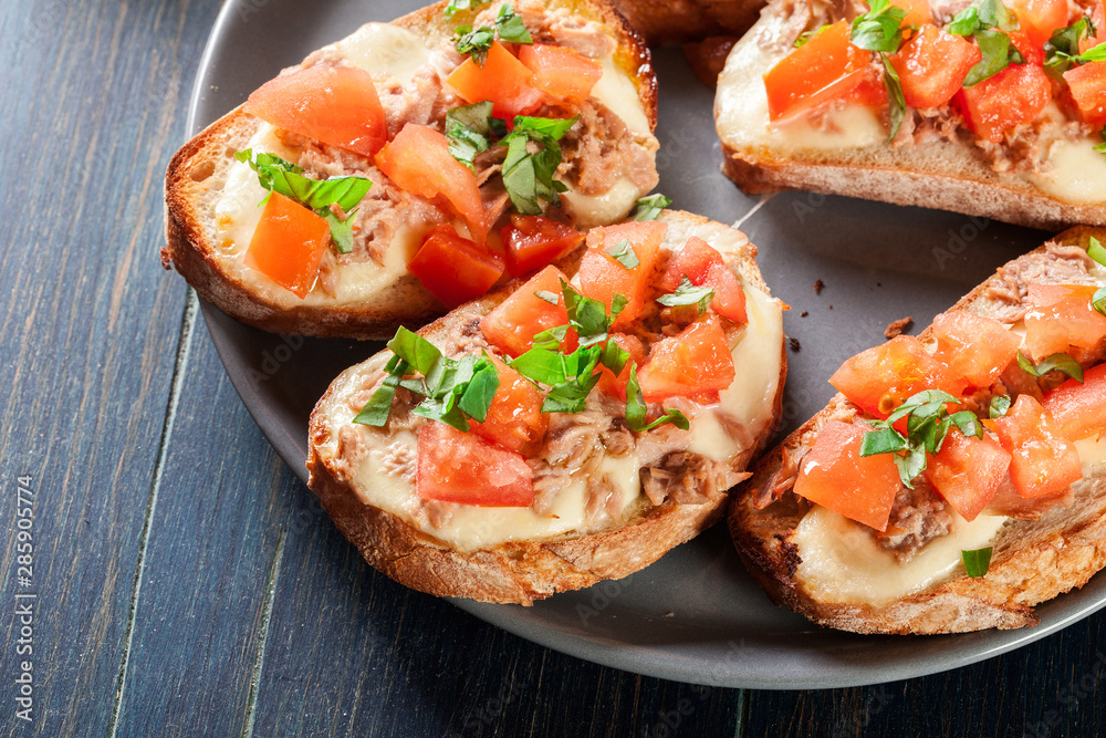 Appetizer bruschetta with tuna, mozarella cheese and tomatoes Appetizer bruschetta with tuna, mozarella cheese and tomatoes