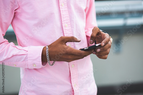 Close up of Black Afro American Man Working with Smartphone