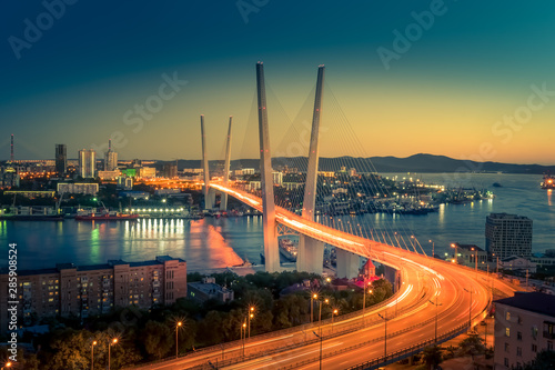 Cityscape overlooking the Golden bridge in blue hour. Bright illumination adorns the night city.