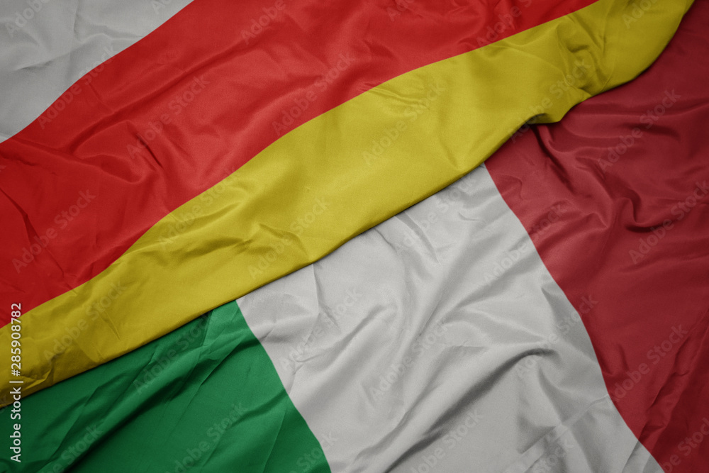 waving colorful flag of italy and national flag of south ossetia. waving colorful flag of italy and national flag of south ossetia.