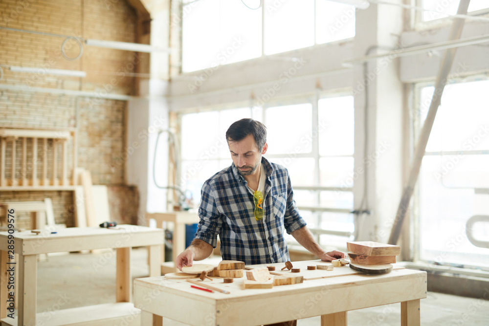 Waist up portrait of mature carpenter working with wood in workshop, copy space Waist up portrait of mature carpenter working with wood in workshop, copy space